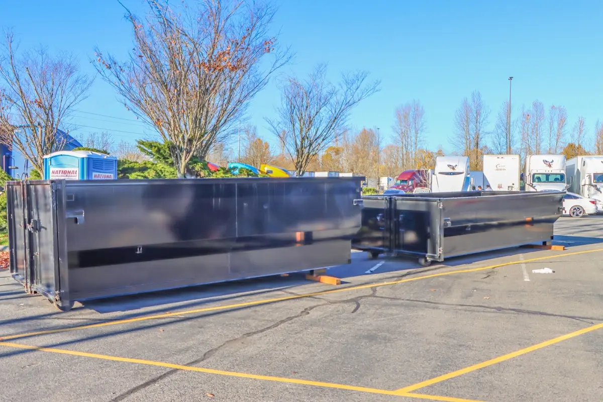 Professional dumpster rental service with roll-off container on residential driveway in Justice